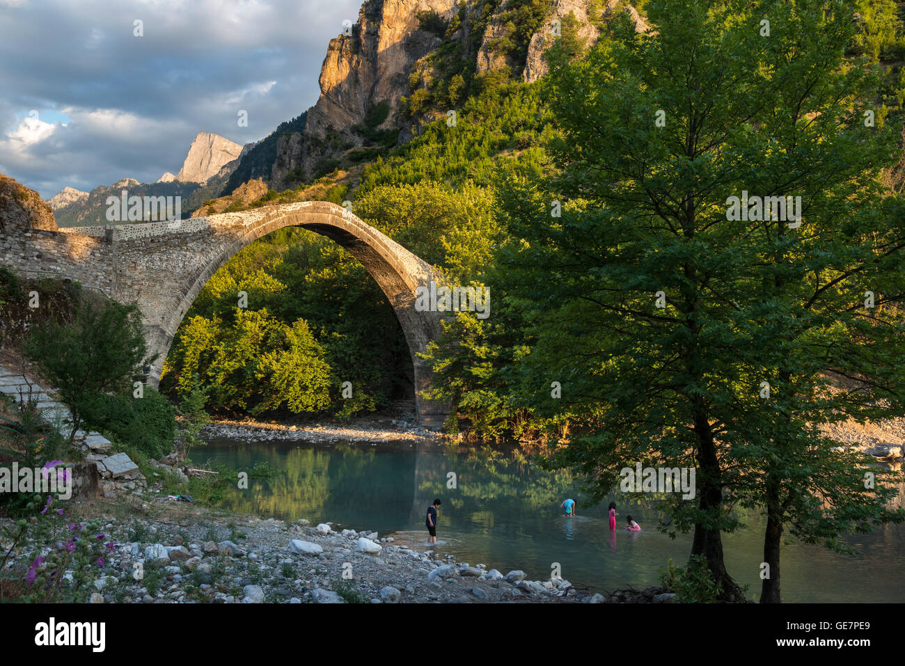 The old stone bridge across the Aoos river at Konitsa with Mount Tymfi