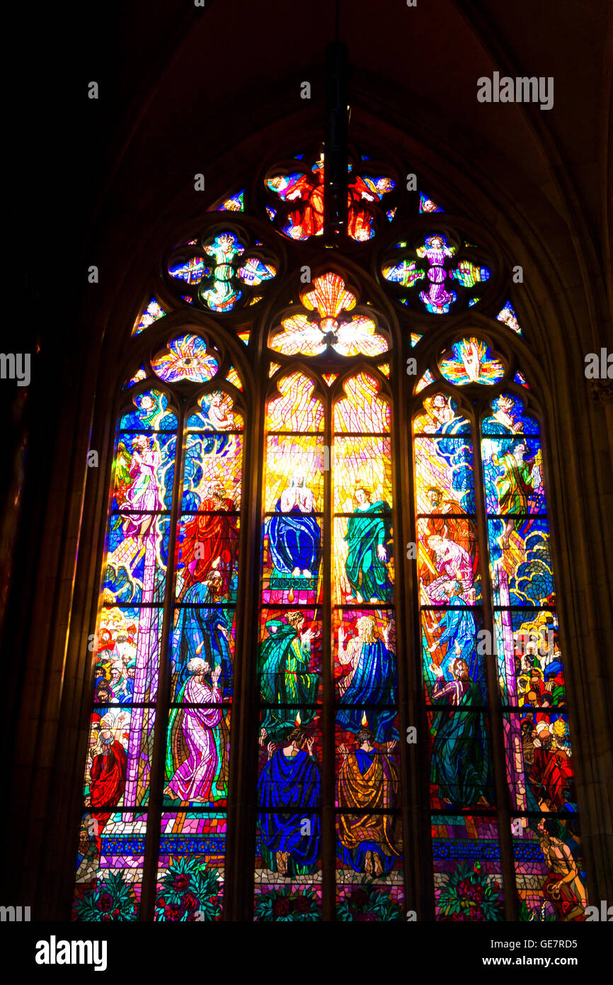 stained glass window in the cathedral of st. Vitus in Prague, depicting a religious scene Stock Photo