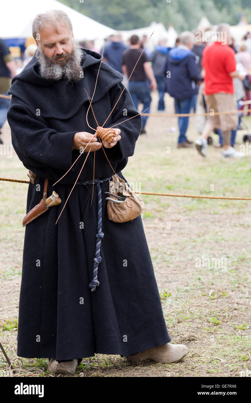 Medieval Monk weaving willow Stock Photo