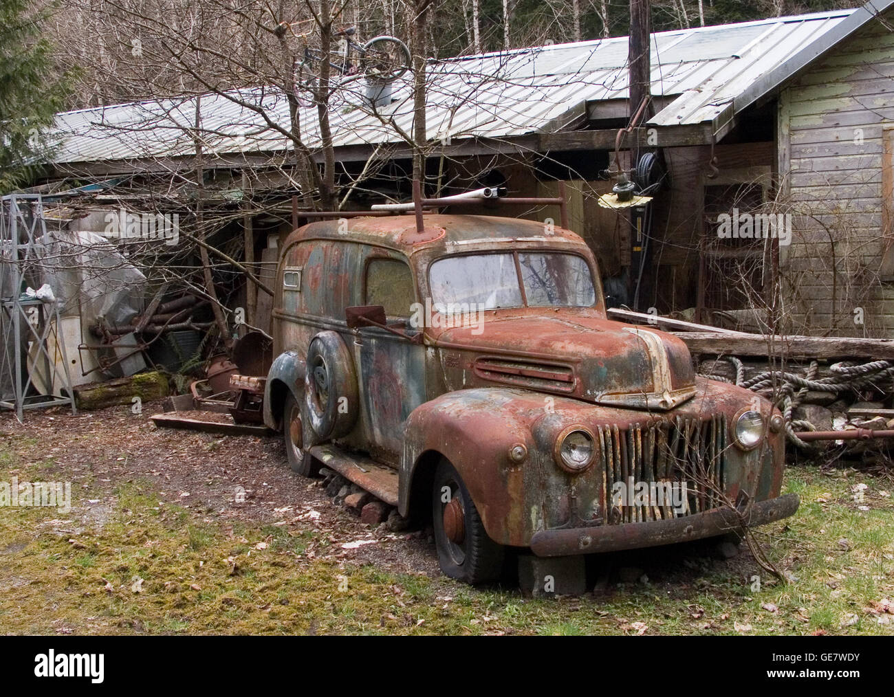 An abandoned Ford truck and deserted and dilapidated business-residence makes the subject for this nostalgic photo study. Stock Photo