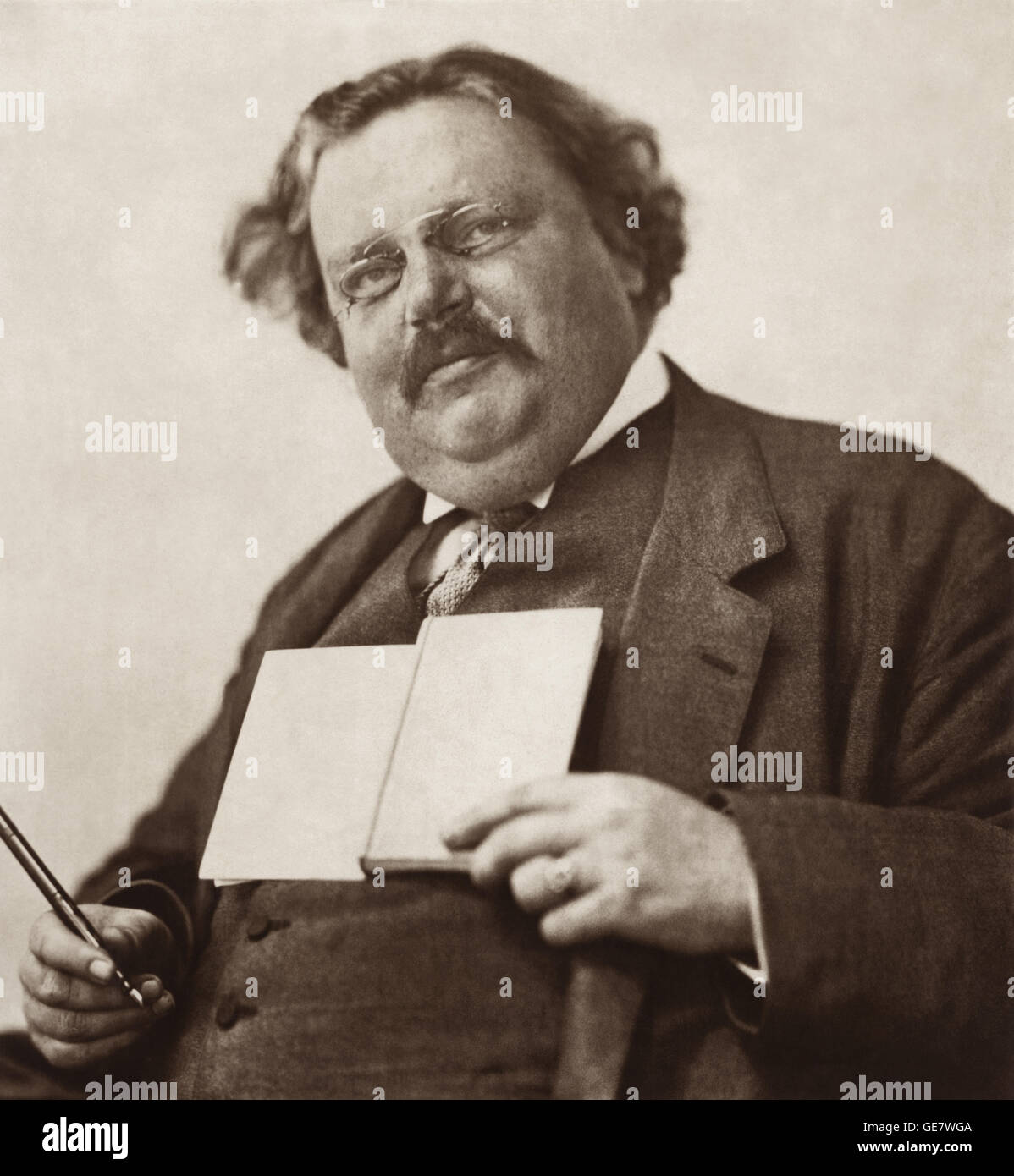 G.K. (Gilbert Keith) Chesterton (shown c1912) was a leading British author, thinker, journalist, arts critic, debater, lay theologian and Christian apologist of the early 20th Century. A prolific writer, he published nearly 100 books and over 4,000 newspaper columns and essays. Stock Photo