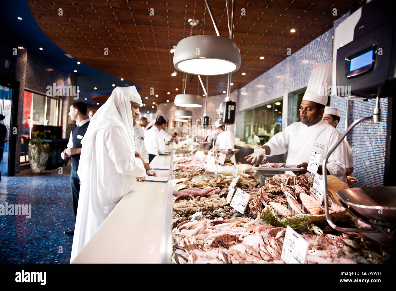 A customer orders fish at L'wzaar Seafood Restaurant in the Katara