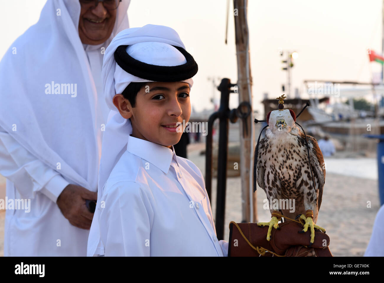 Qatari boy holding a falcon, Katara Traditional Dhow Festival, Doha