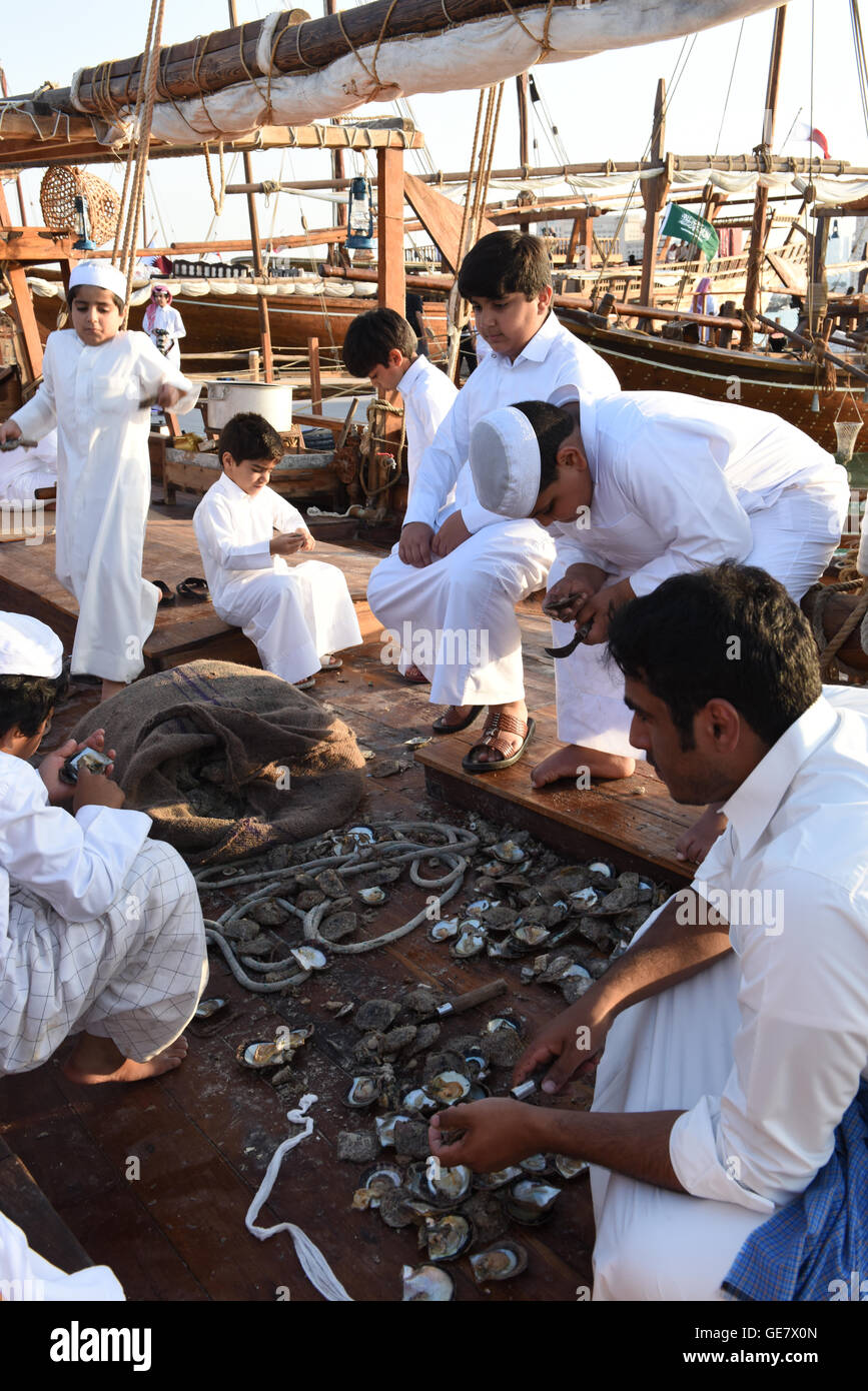 Group opening oysters on the Dhow, Katara Traditional Dhow Festival