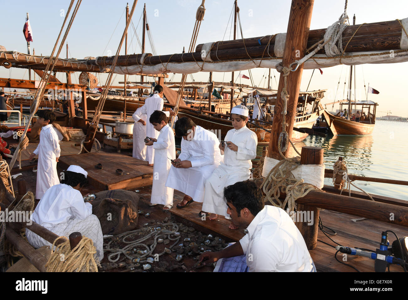 Group opening oysters on the Dhow, Katara Traditional Dhow Festival