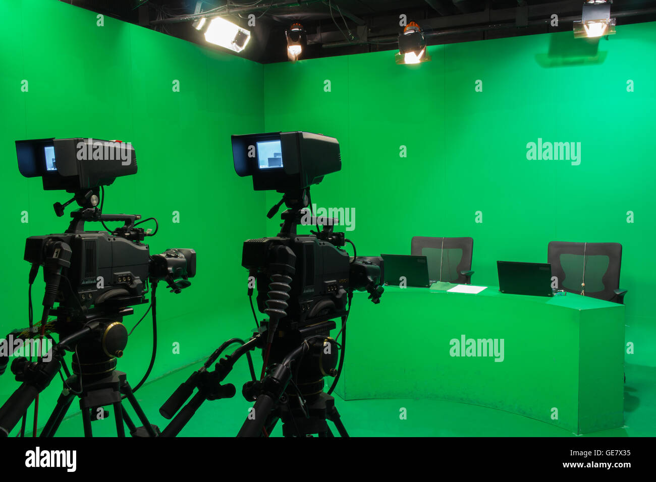 Television studio with camera and lights - camera on tripod: Shallow depth of field Stock Photo