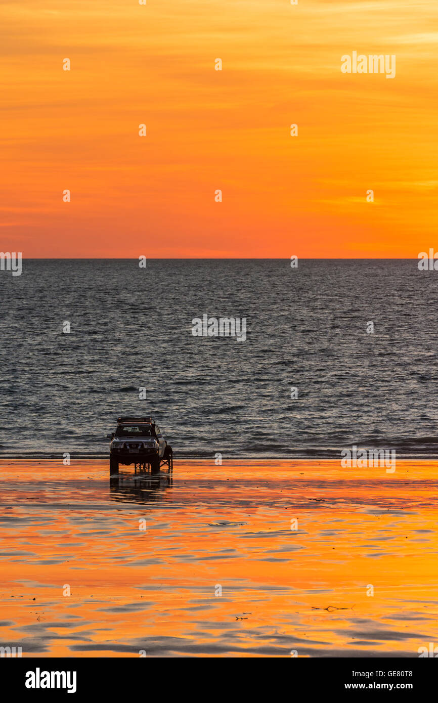 A four wheel drive vehicle parked on Cable Beach at sunset, Broome, Kimberley, Western Australia, Australia Stock Photo