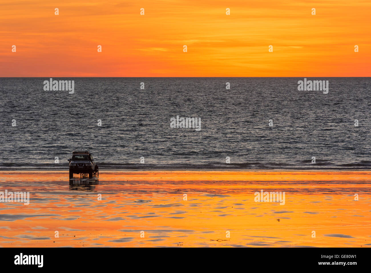 Broome's Cable Beach at sunset, with a four wheel drive vehicle parked on the golden sands, Broome, Kimberley, Western Australia, Australia Stock Photo