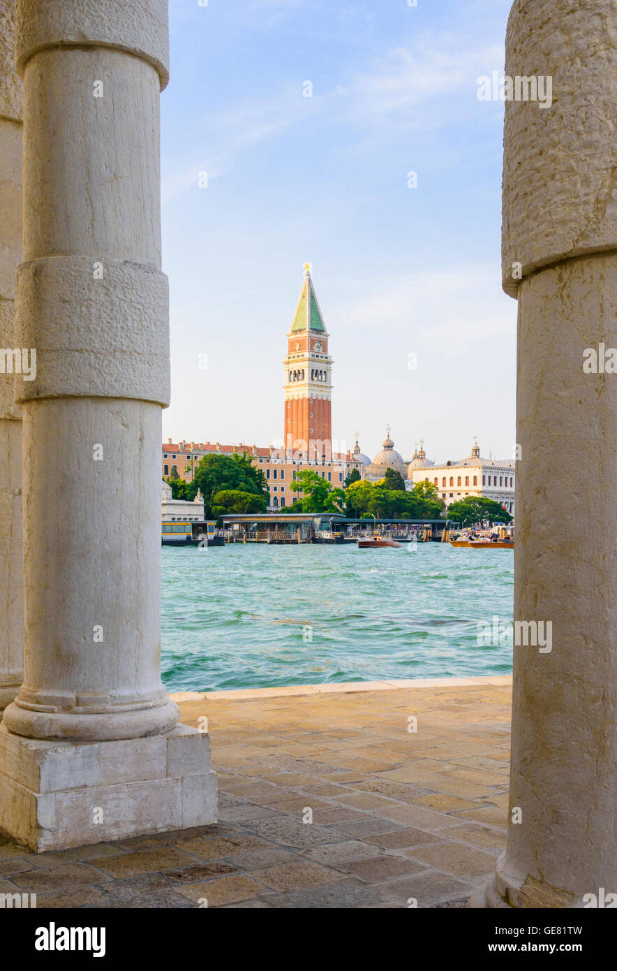 Views of St Mark's Campanile through the columns of the old customs house, Punta della Dogana, Dorsoduro, Venice, Veneto, Italy Stock Photo