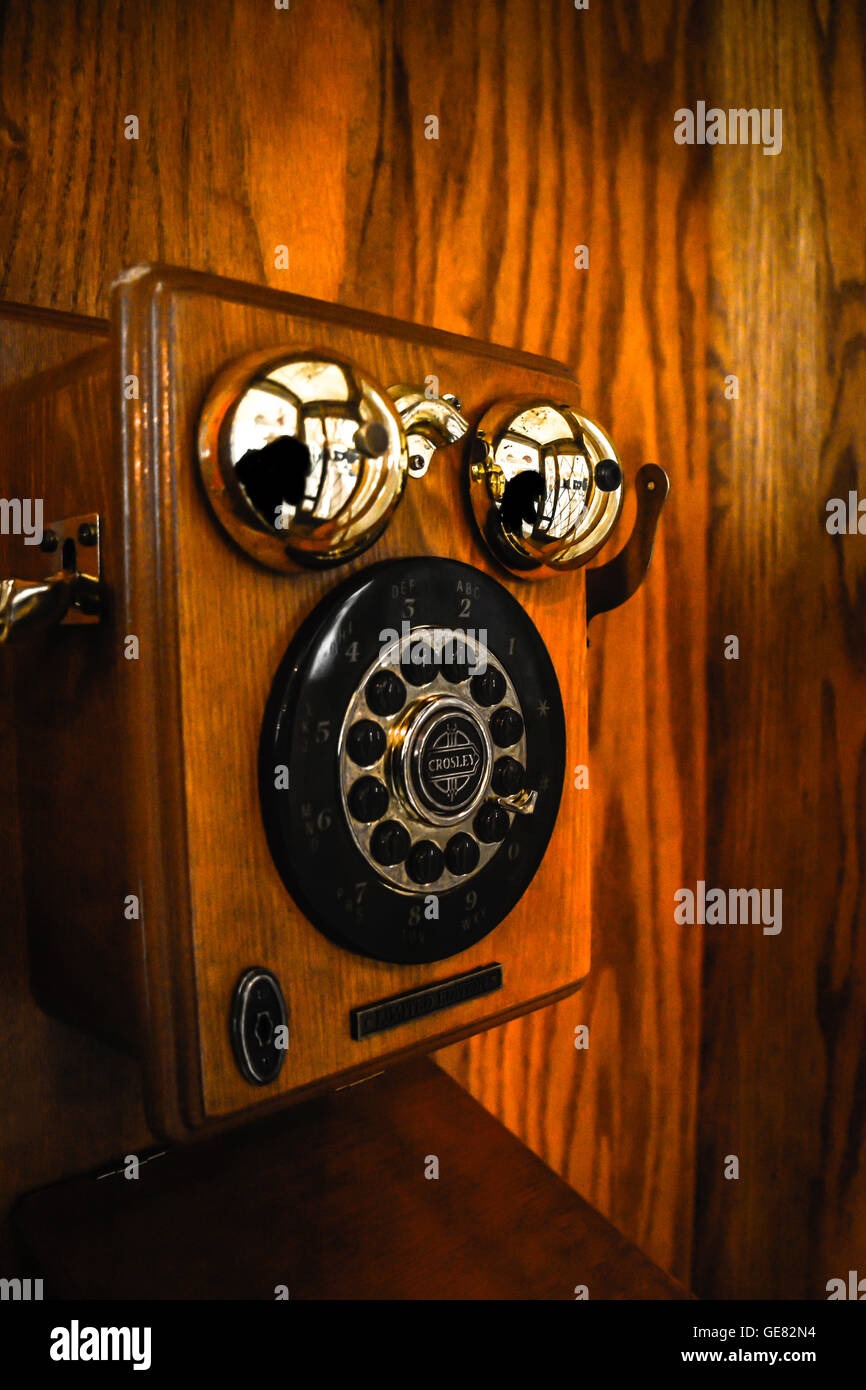 A moody and nostalgic view Inside a vintage wooden pay telephone booth Stock Photo