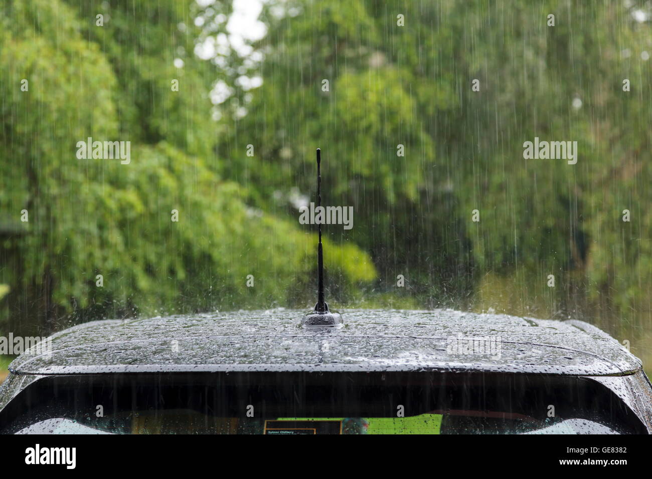 Heavy rain falling on a car roof Stock Photo Alamy