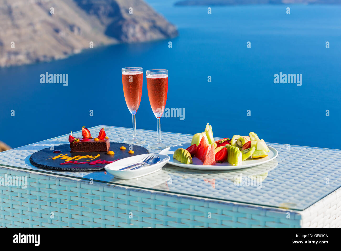 Wine and fruit for two on the beach, Santorini, Greece Stock Photo