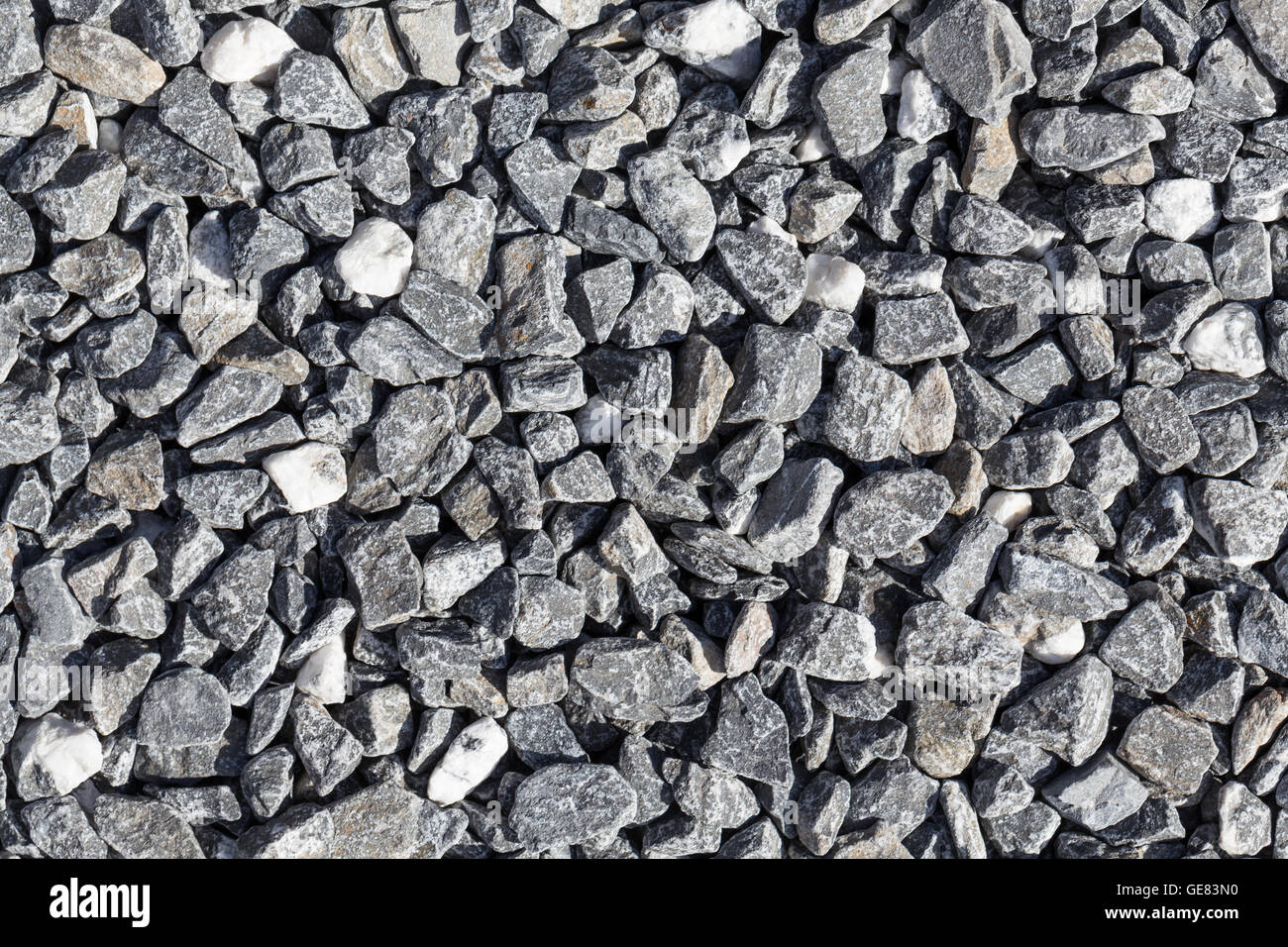 Crushed grey stone on the ground texture background Stock Photo - Alamy