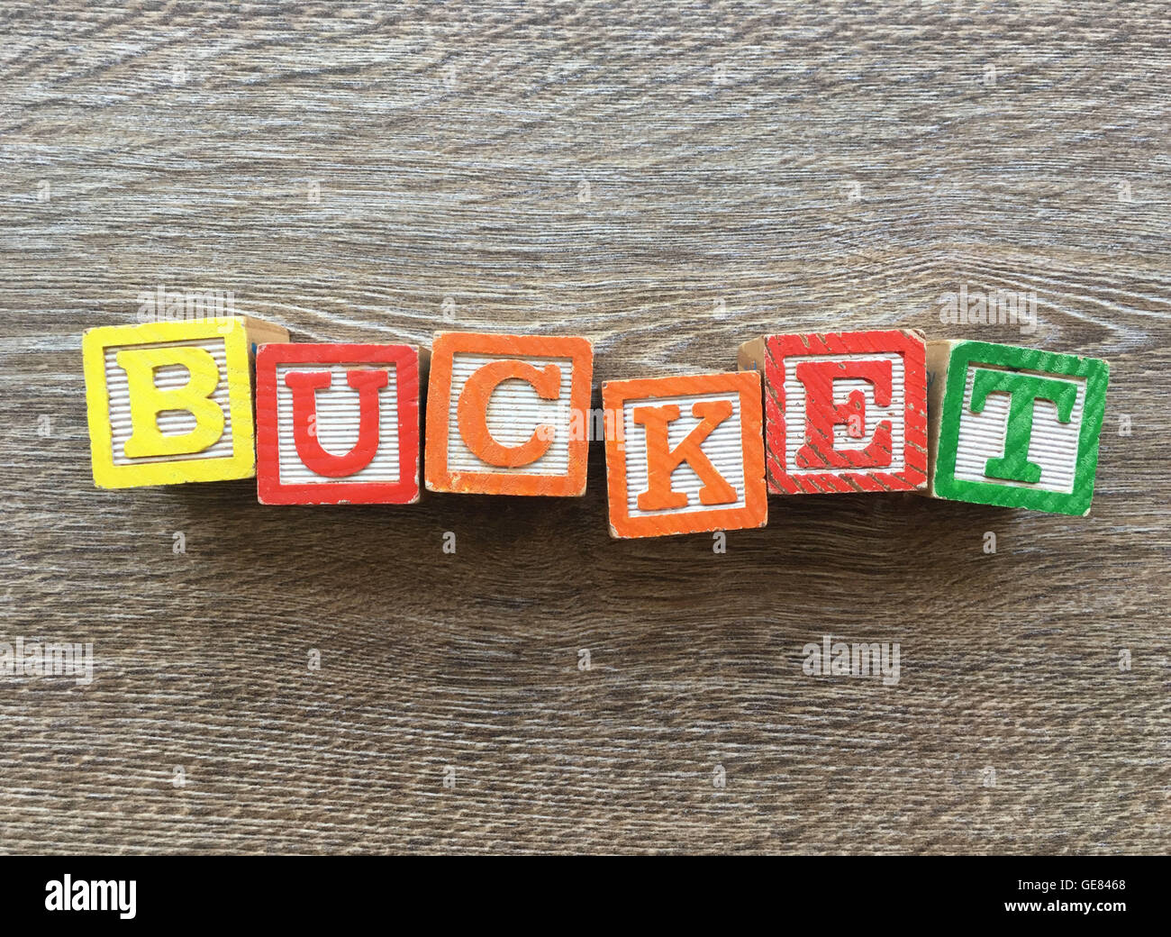 Wood blocks or wooden cubes toys with alphabet letters on them combined together to create the