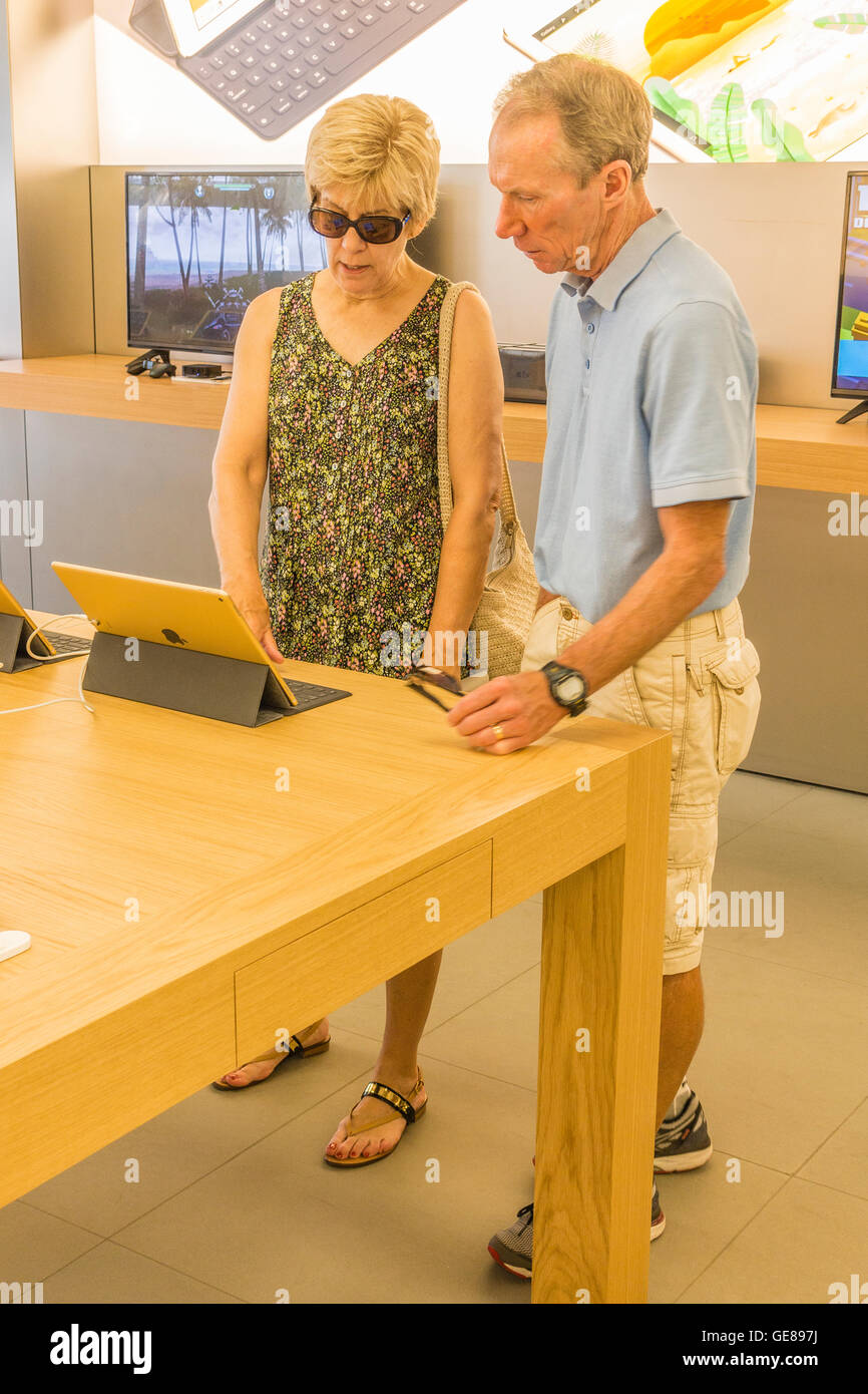 A senior couple shops for a laptop at the Apple Store in Santa Barbara