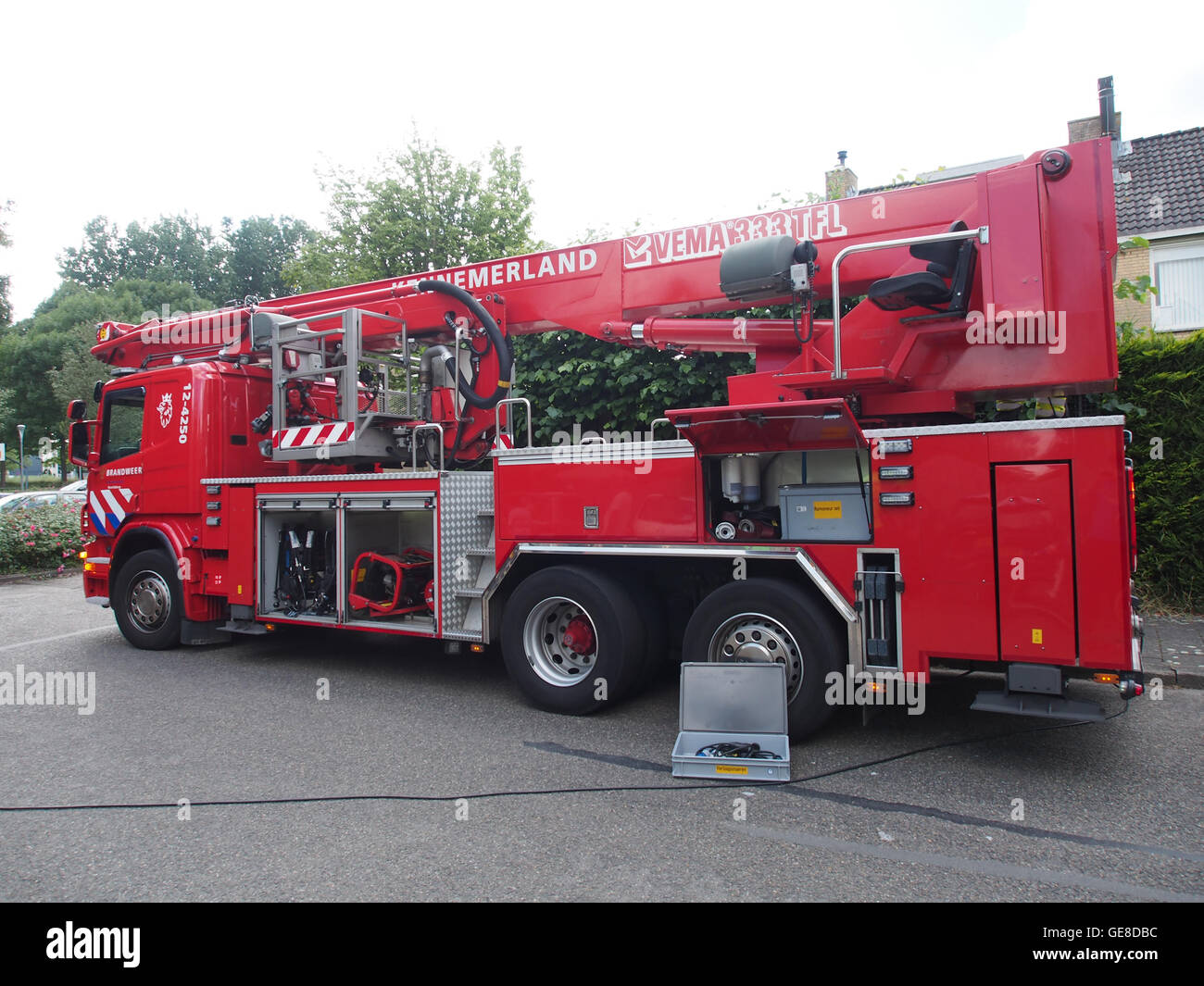 A photo of a P400 SCANIA fire truck, Unit 12-4250, stationed in Hoofddorp,  Netherlands. This fire truck is part of the modern fleet of fire-fighting  vehicles used in the region for emergency