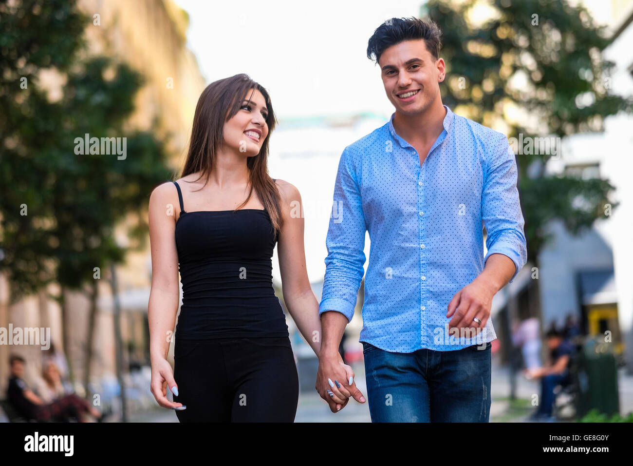 Happy young walking hand in hand hi-res stock photography and images ...