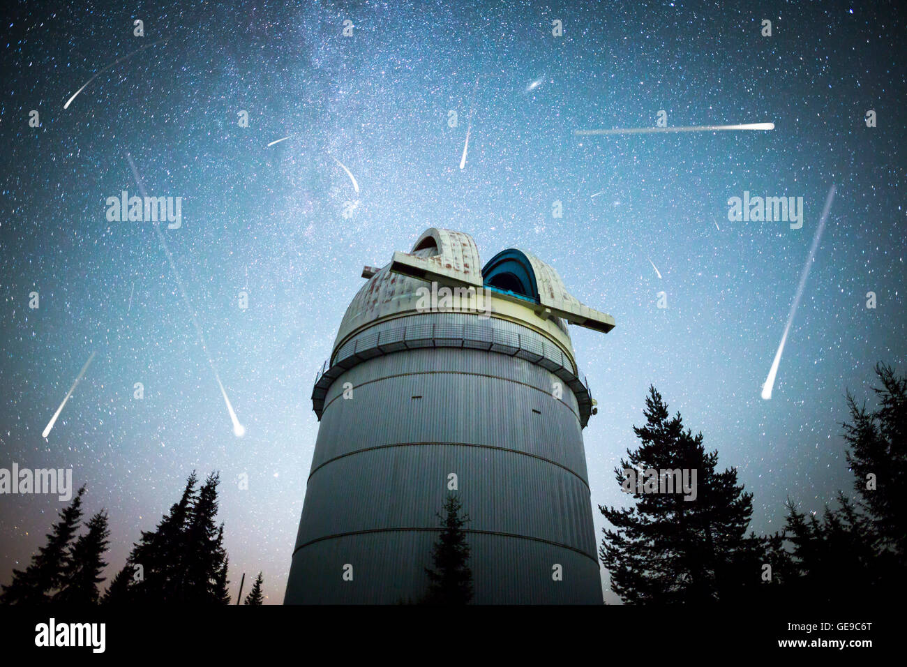 Rozhen astronomical observatory under the night sky stars. Blue sky with hundreds of stars of the Milky way. Observatory in a pi Stock Photo