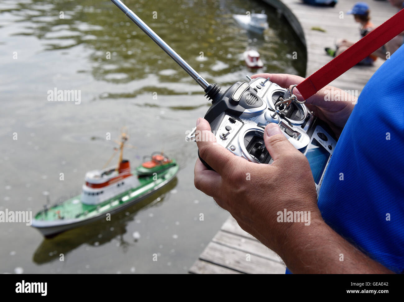 Berlin, Germany. 24th July, 2016. With a remote control, a rescue boat is  controlled at 6th Great Model Ships meeting in the Britz Garden in Berlin,  Germany, 24 July 2016. Photo: Rainer