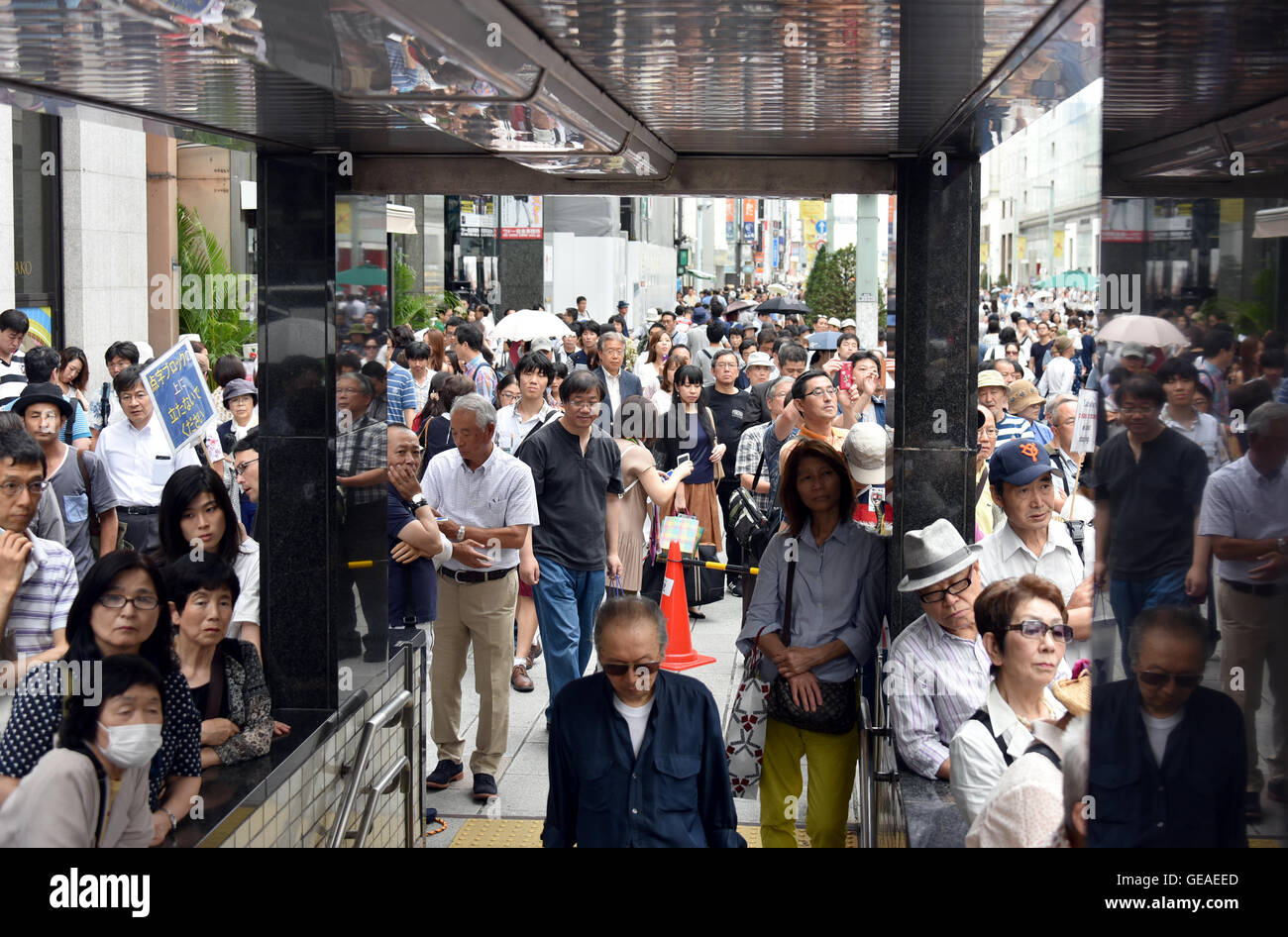 July 24, 2016, Tokyo, Japan - Holiday goers and Sunday shoppers stop and listen to Japans free journalist Shuntaro Torigoe deliver his speech at Tokyos bustling Ginza Street on July 24, 2016, in his last week of campaigning for the July 31 gubernatorial election. With the voting date one week away, Torigoe, 76, who has the backing from four opposition parties, is trailing former Defense Minister Yuriko Koike in the race according to latest surveys. (Photo by Natsuki Sakai/AFLO) AYF -mis- Stock Photo