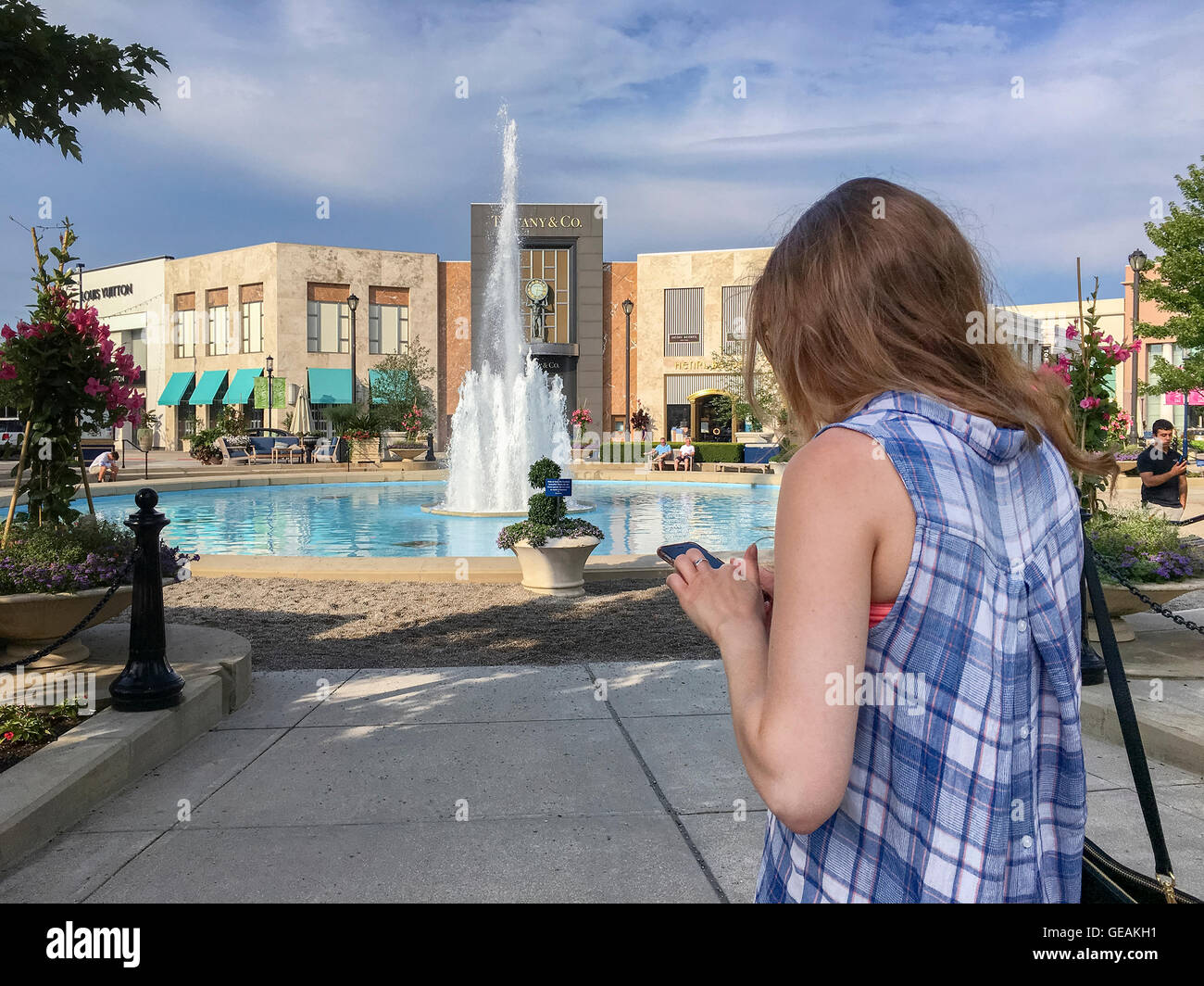 Columbus, Ohio, United States. 24th July, 2016. COLUMBUS, OHIO - JULY 24: A young woman catches a Pokemon, playing Pokemon Go at the the Easton Town Center mall on July 24, 2016. The location-based augmented reality mobile game by Niantic Labs launched in early July 2016. Credit:  2016 Marianne A. Campolongo/Alamy Live News Stock Photo