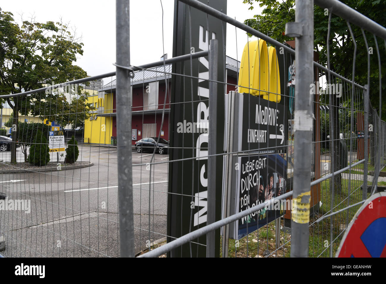 Munich, Germany. 25th July, 2016. Barriers seen in front of a McDonald's fast food restaurant located on the opposite side of the Olympia-Einkaufszentrum (OEZ, lit. Olympics Shopping Mall) in Munich, Germany, 25 July 2016, three days after a shootout that left numerous people dead and injured. The incident began in the restaurant that is currently surrounded by a black plastic sheet, with its windows taped shut. The fatal shots were fired by a 18-year-old German Iranian man. Ten people including the attacker died as a result. Photo: PETER KNEFFEL/dpa/Alamy Live News Stock Photo