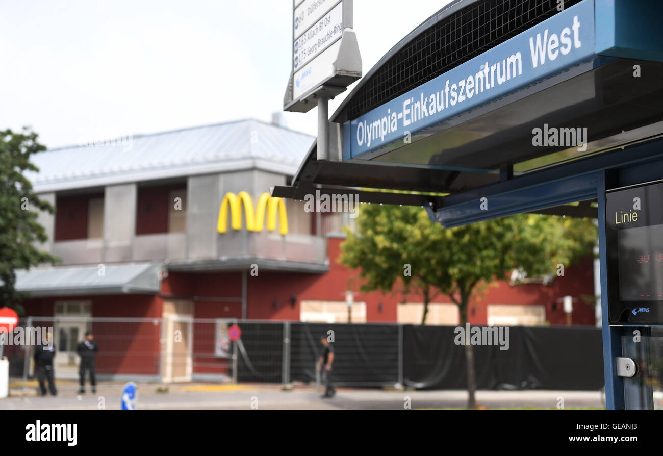 Munich, Germany. 25th July, 2016. Barriers with black plastic sheets seen in front of a McDonald's fast food restaurant located on the opposite side of the Olympia-Einkaufszentrum (OEZ, lit. Olympics Shopping Mall) in Munich, Germany, 25 July 2016, three days after a shootout that left numerous people dead and injured. The incident began in the restaurant that is currently surrounded by a black plastic sheet, with its windows taped shut. The fatal shots were fired by a 18-year-old German Iranian man. Ten people including the attacker died as a result. Photo: PETER KNEFFEL/dpa/Alamy Live News Stock Photo
