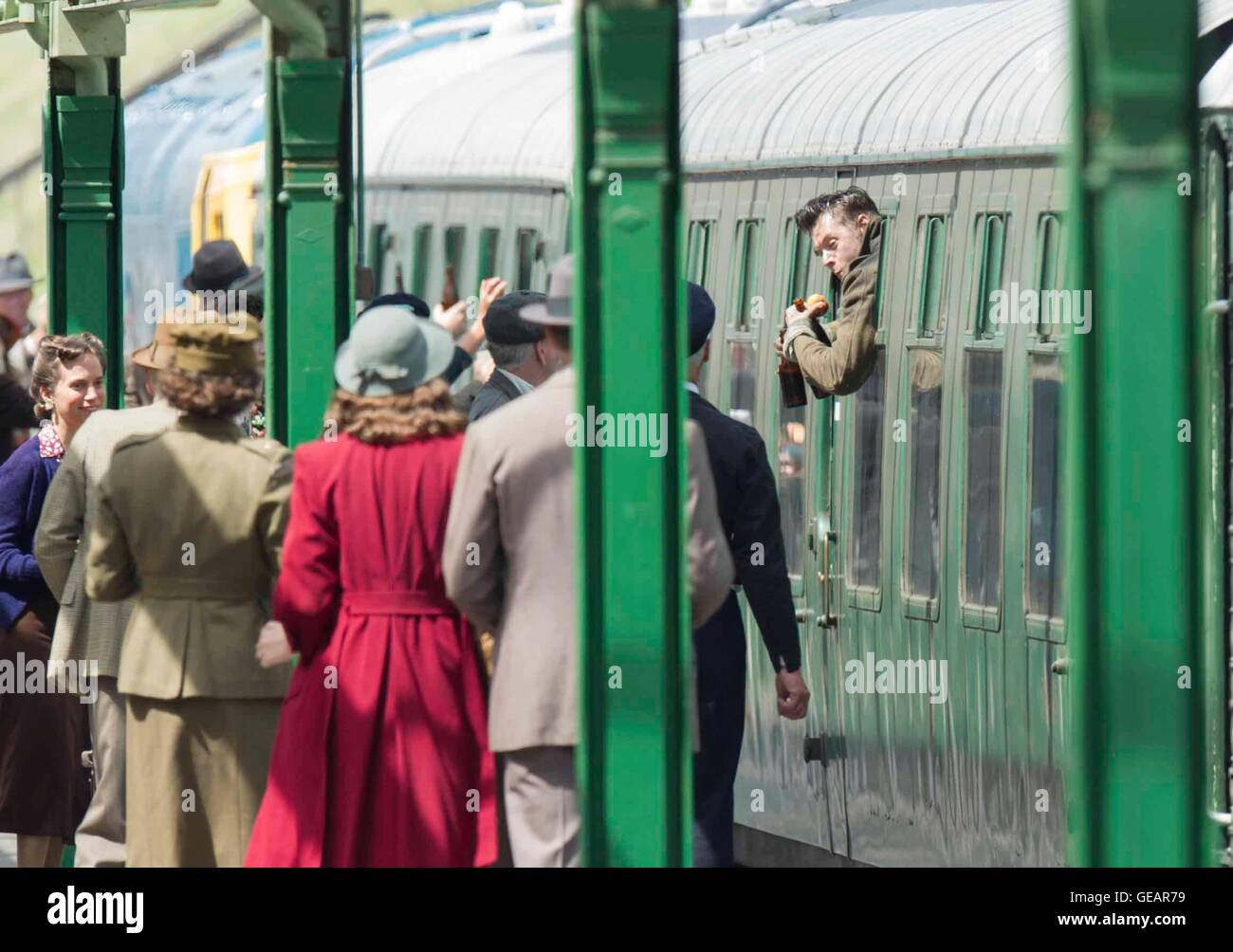 Swanage Station, Dorset, UK.  25th July 2016. Filming of Dunkirk (Bogeda Bay) at Swanage Station in Dorset.  Harry Styles filming a scene at Swanage station, which doubles as Woking, where he swiggs beer and eats apples while hanging out of the train window on arrival to the platform.  Photo by Graham Hunt/Alamy Live News Stock Photo