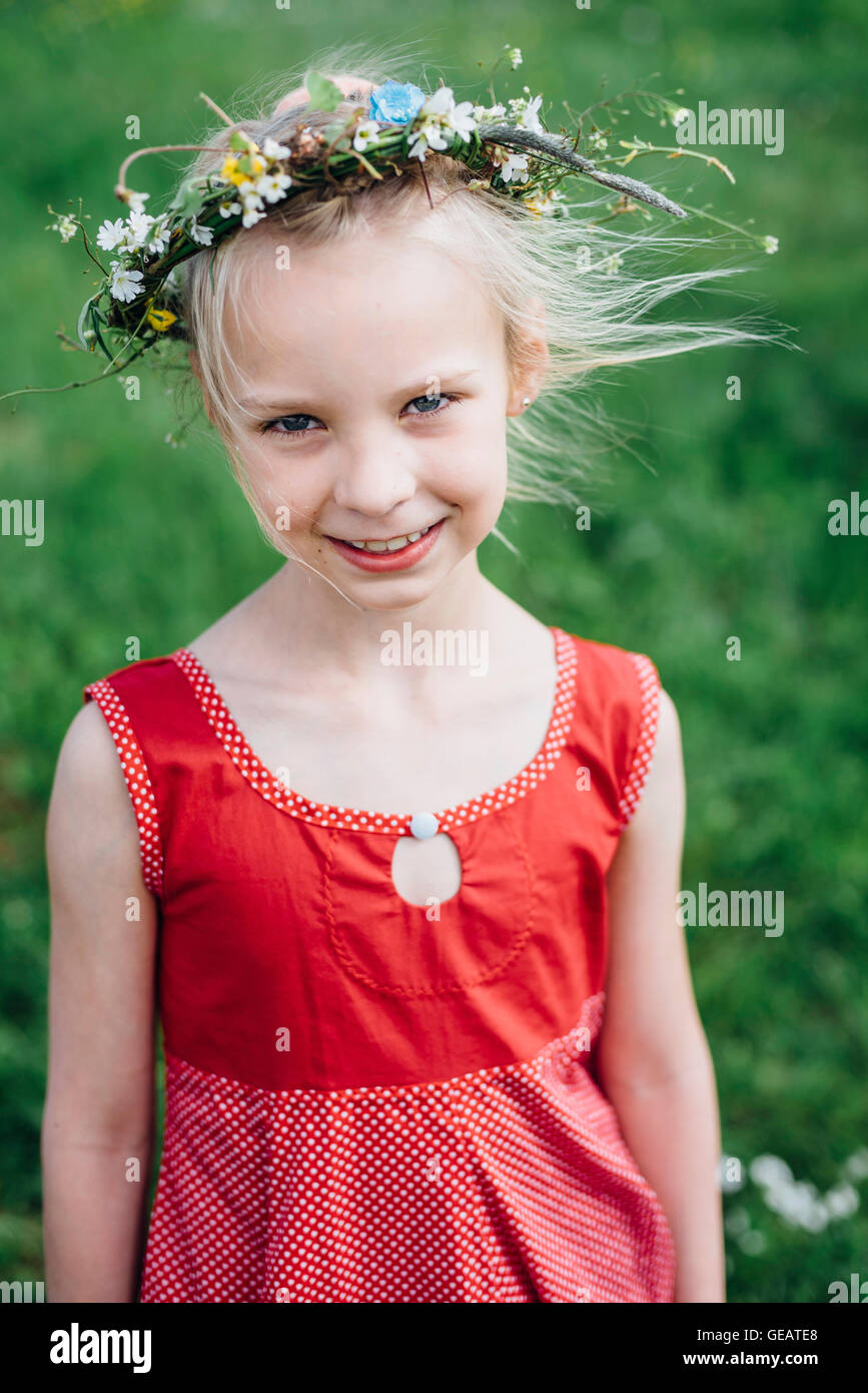 Portrait of smiling girl wearing flower wreath Stock Photo - Alamy