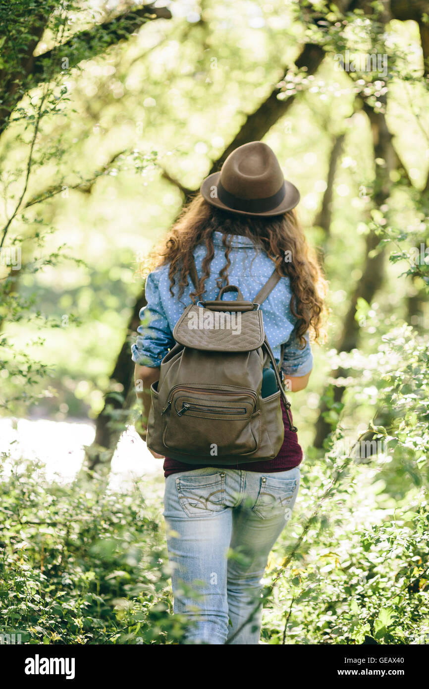 Back view of hiking young woman with backpack Stock Photo - Alamy