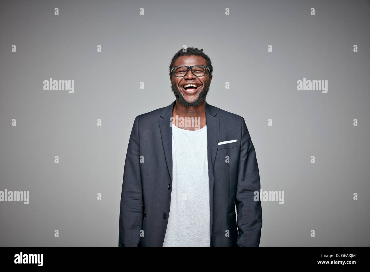 Portrait of laughing man wearing glasses and jacket Stock Photo - Alamy