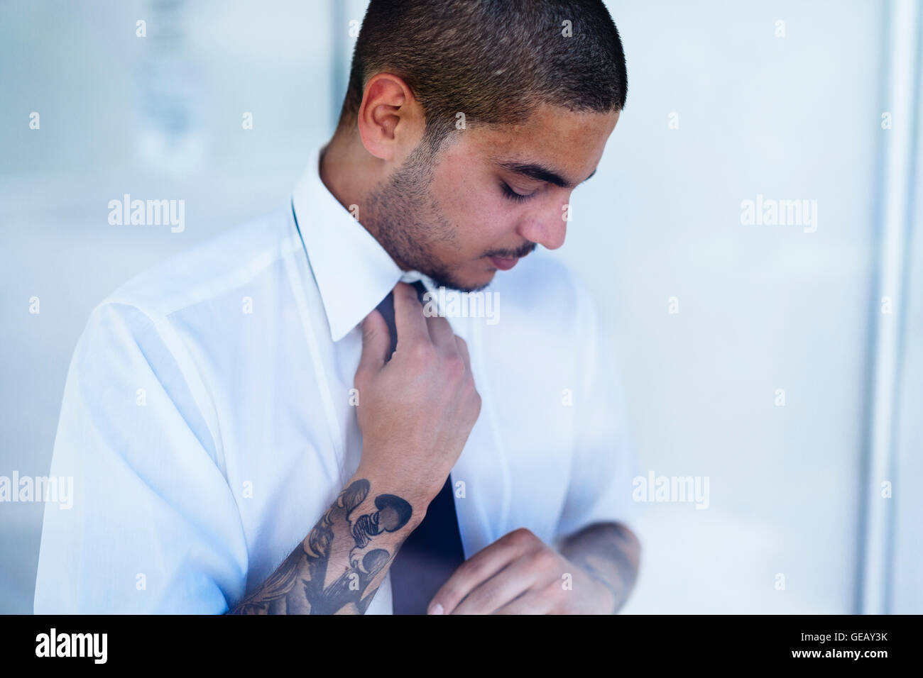 Young businessman binding tie Stock Photo