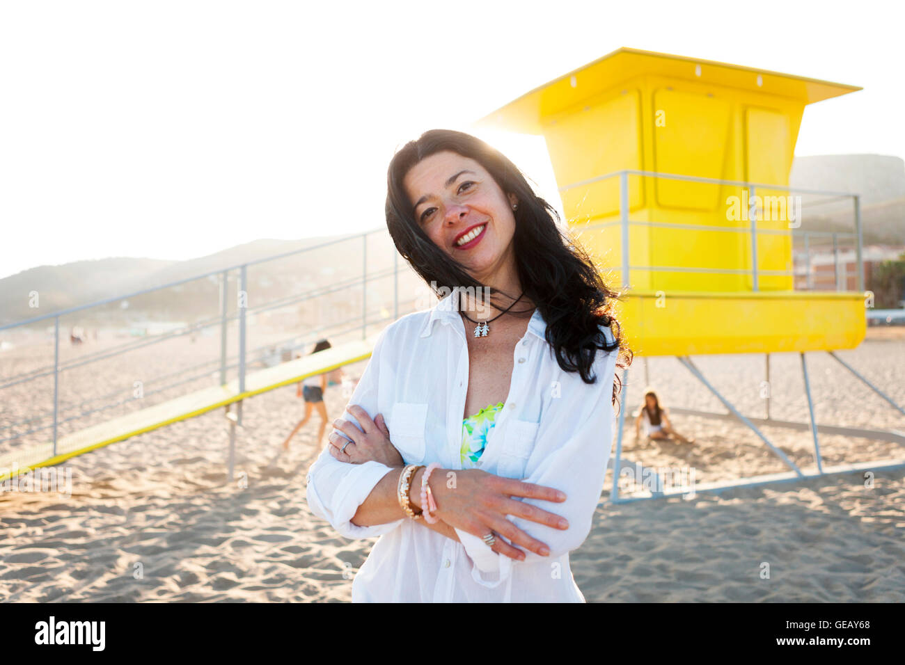 Portrait of smiling woman on the beach Stock Photo - Alamy