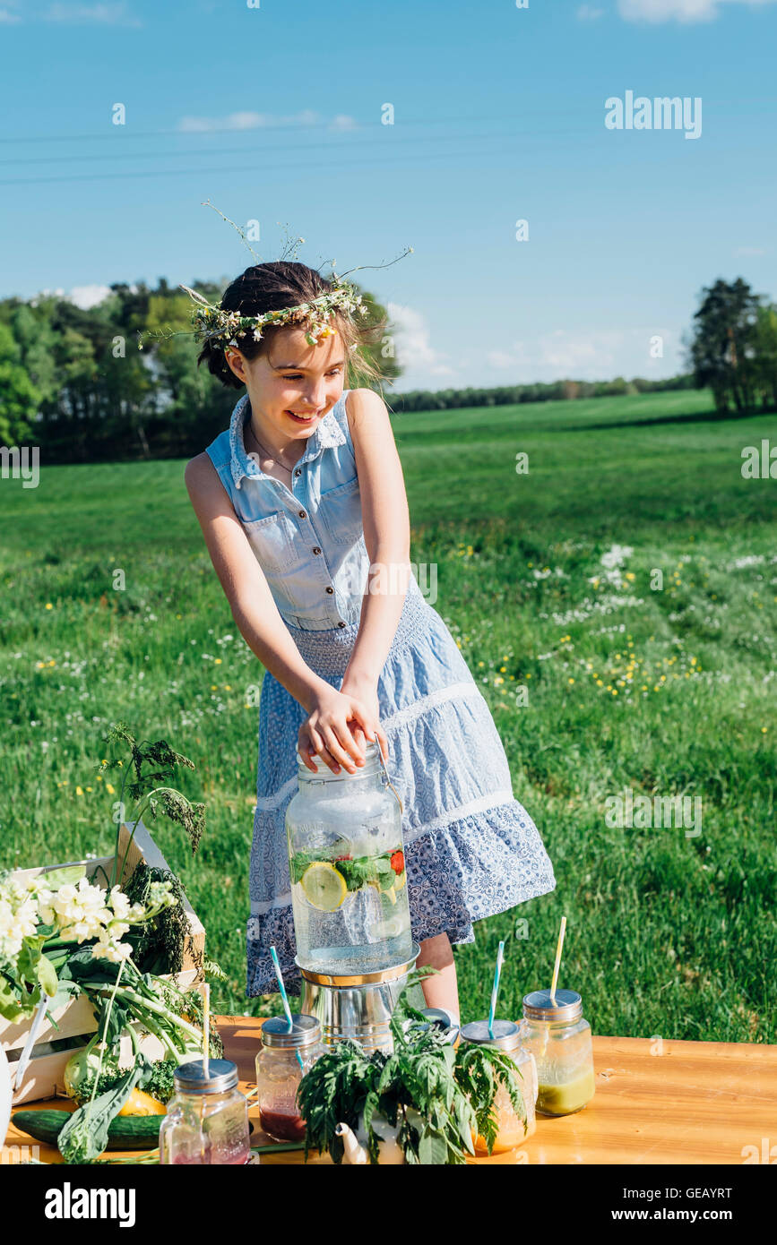 Smiling girl wearing flower wreath on meadow Stock Photo - Alamy