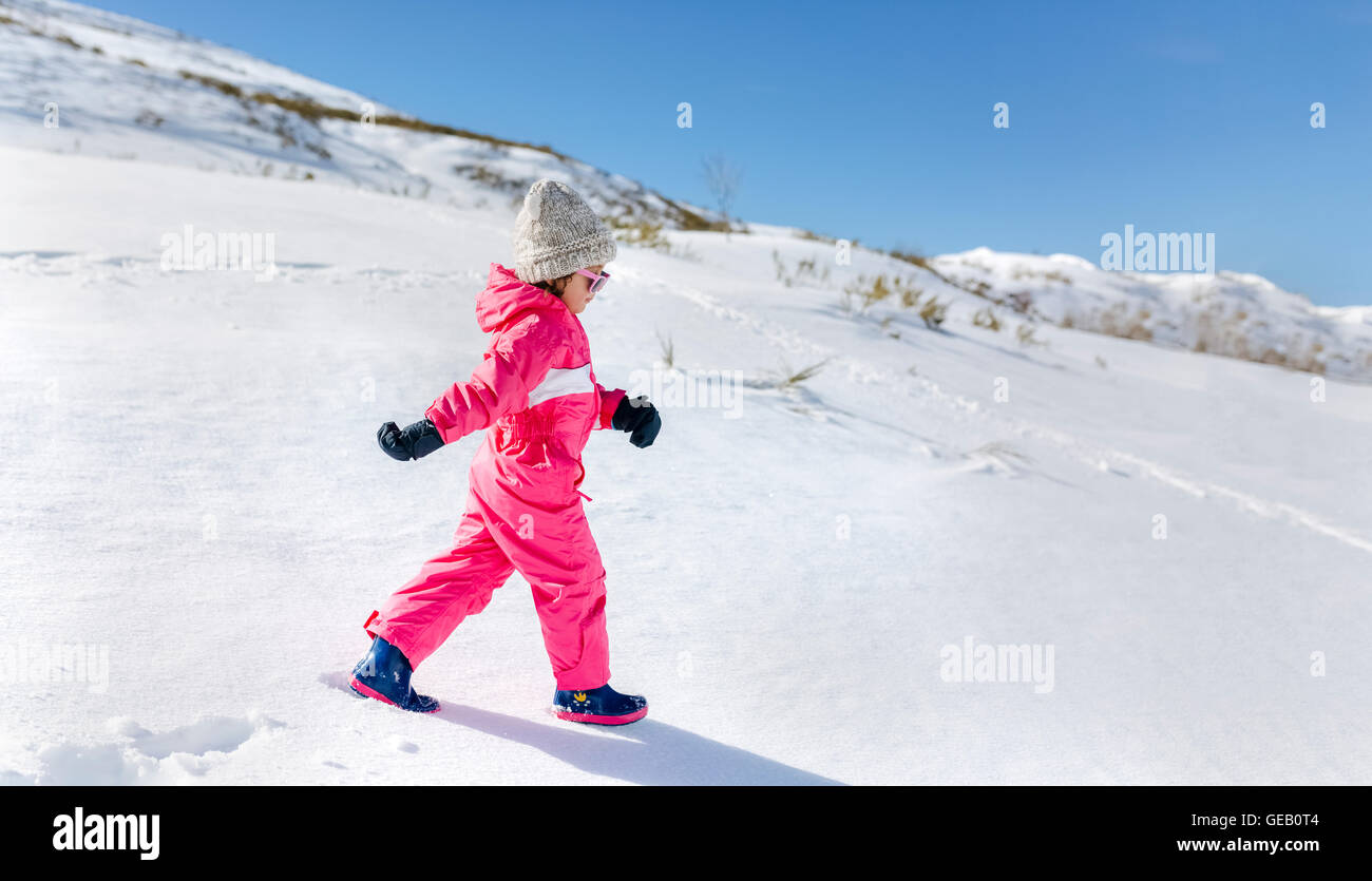 Little girl walking in snow Stock Photo Alamy