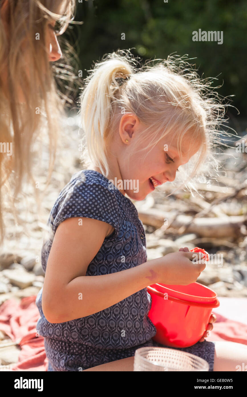 Portrait of smiling little girl at riverside Stock Photo - Alamy