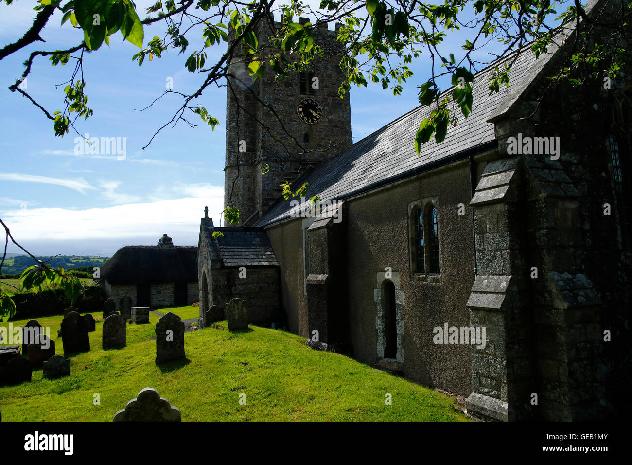 Saxon church at Buckland-in-the-moor with the famous clock face 'My Dear Mother' commissioned by the Whiteley family in memory Stock Photo