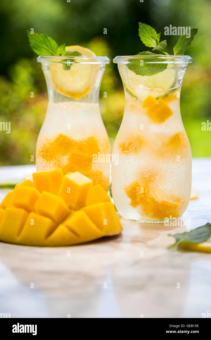 Fruit infused water with mango, lime and lemon Stock Photo Alamy