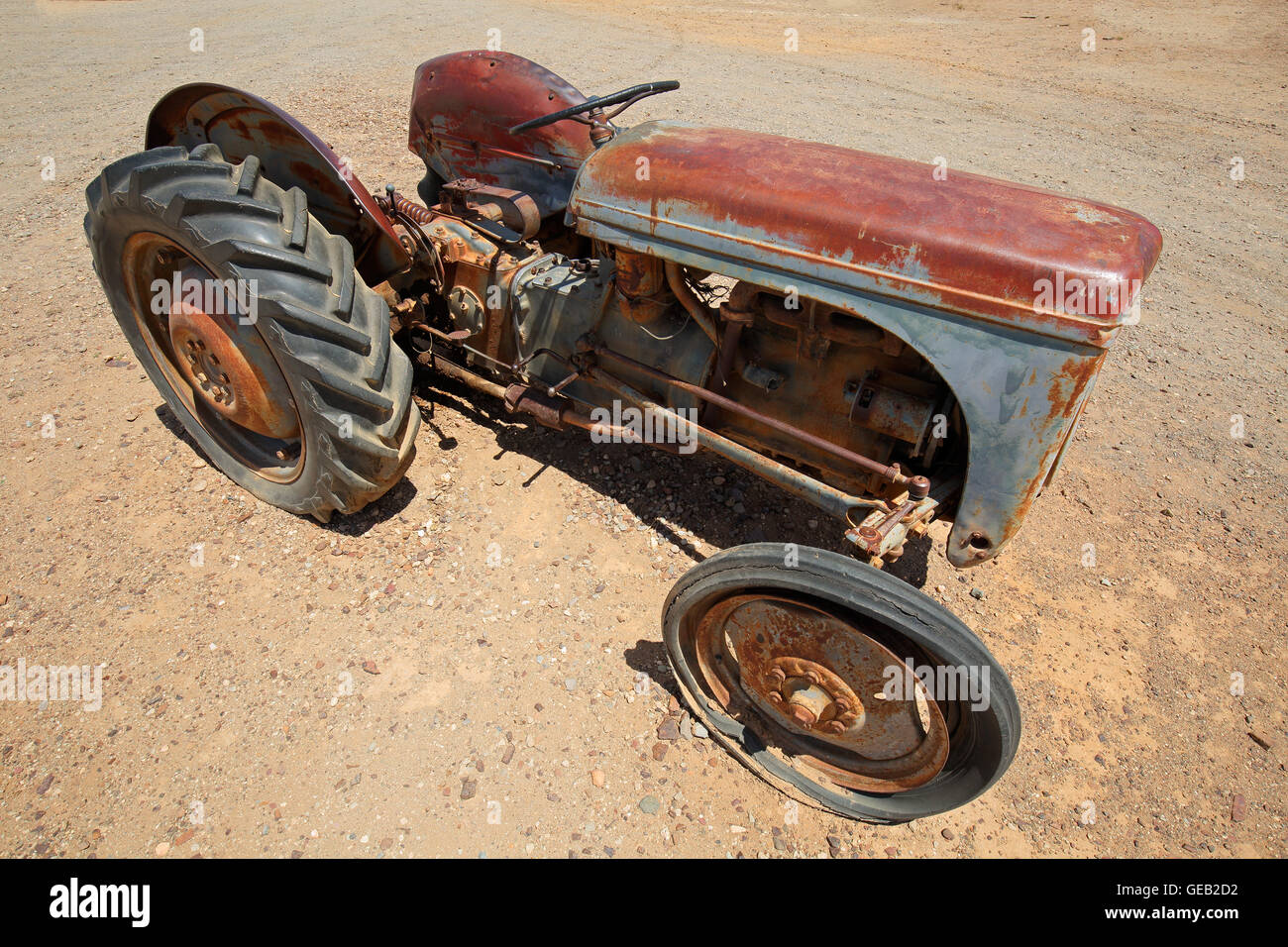 Rusty old tractor abandoned out in the field Stock Photo