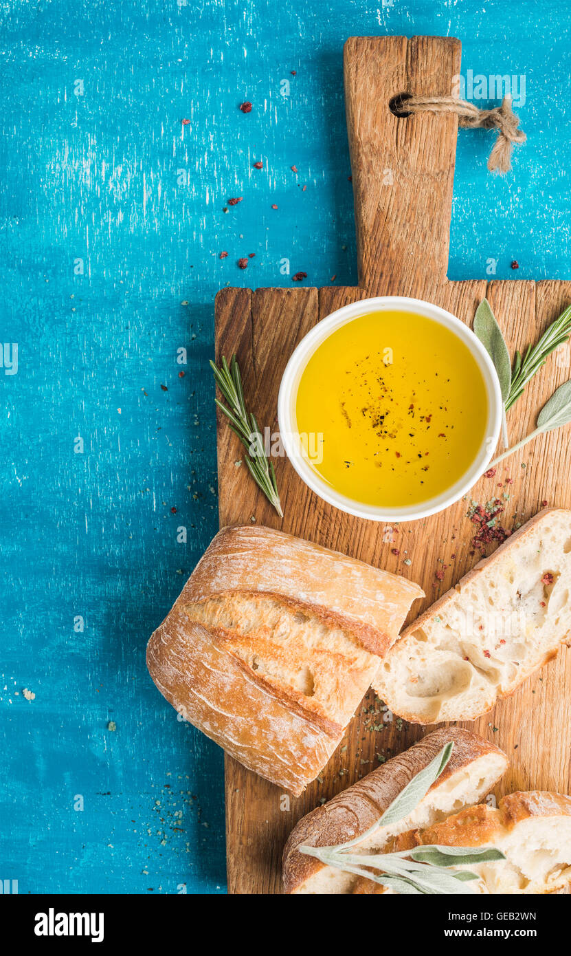 Mediterranean snacks set. Olive oil, herbs and sliced ciabatta bread on