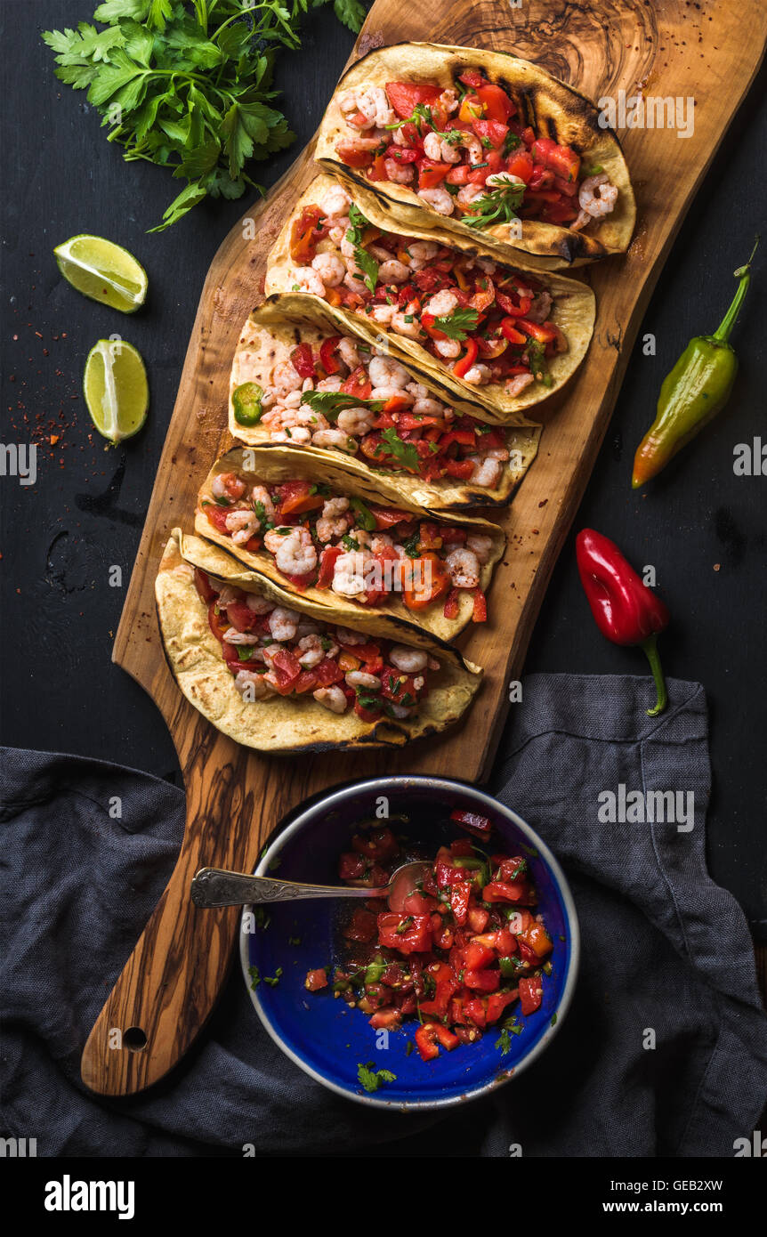Shrimp tacos with homemade salsa, limes and parsley Stock Photo