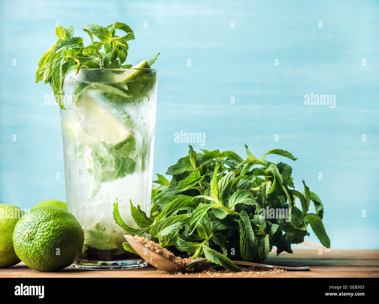 Mojito summer cocktail in tall glass with mint, brown sugar and limes Stock Photo