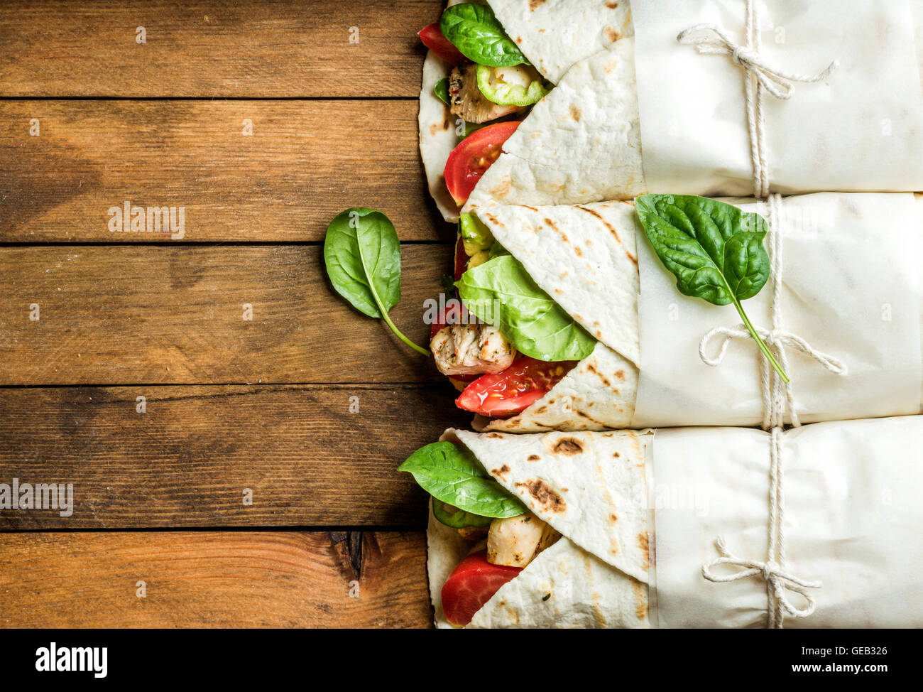 Healthy lunch snack. Tortilla wraps with grilled chicken fillet and