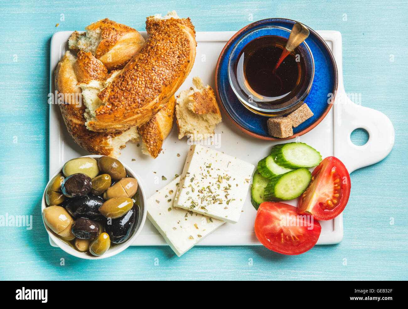 Turkish traditional breakfast with feta cheese, vegetables, olives, simit bagel and tea Stock Photo