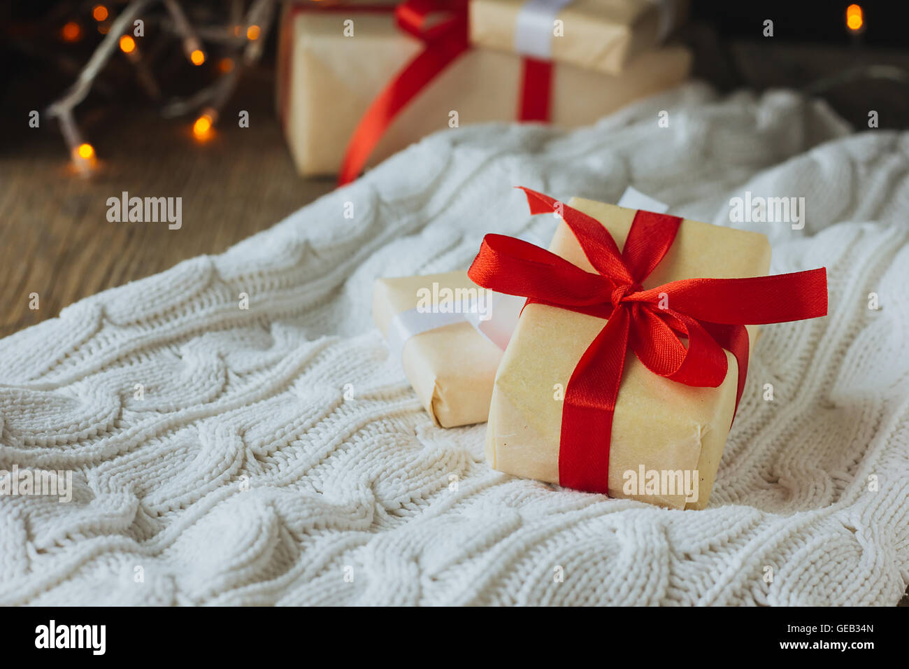 Two Christmas presents on white pullover selective focus Stock Photo