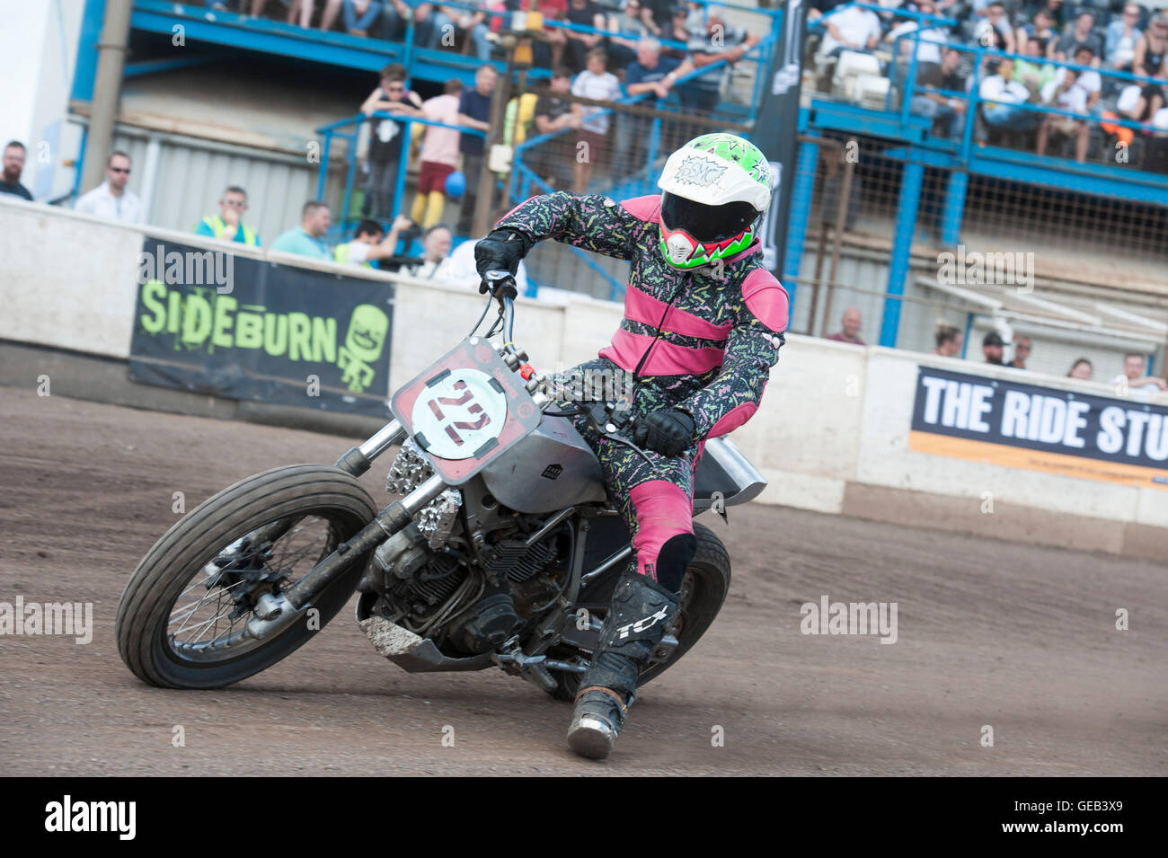 Kings Lynn, Norfolk, United Kingdom. 16.07.2016. Fifth annual Dirt Quake festival with Guy Martin and Carl 'Foggy' Fogarty.  A racer in retro pink leathers. Stock Photo