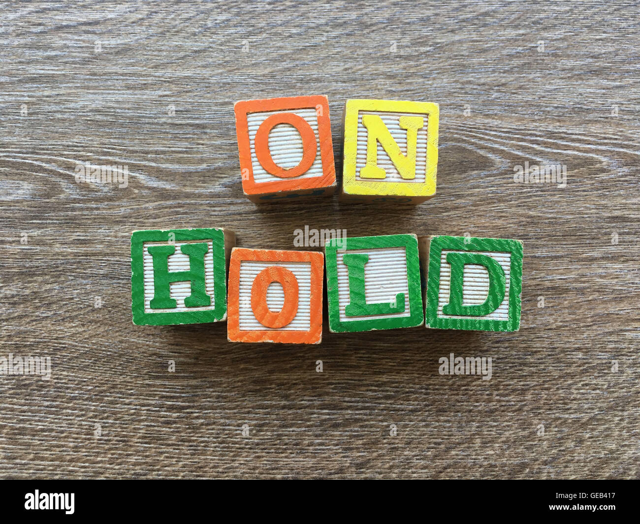 ON HOLD sentence written with wood block letter characters Stock Photo