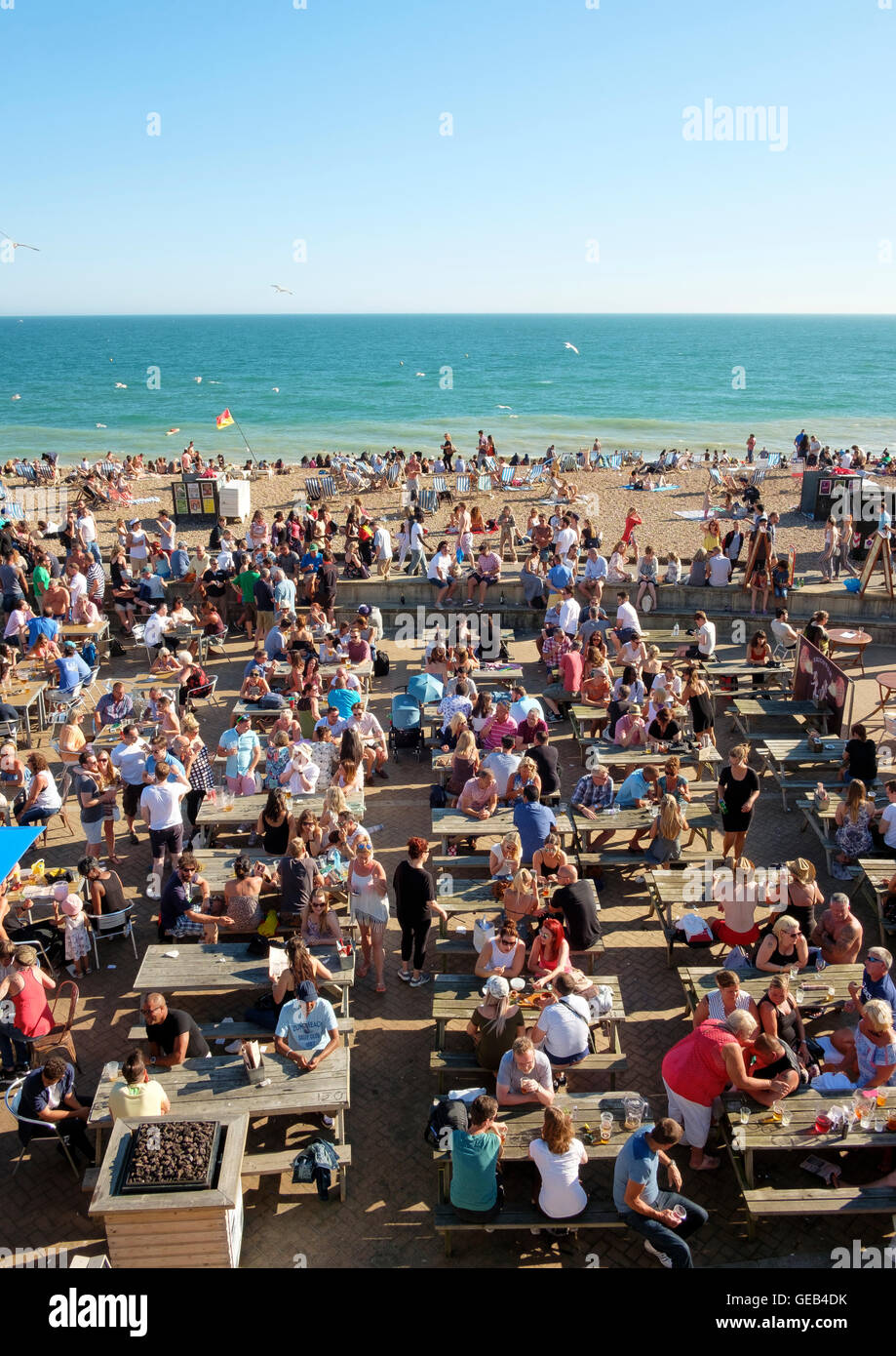 Brighton, UK - 23 July 2016: People on a summer Saturday sitting and drinking at the Brighton Music Hall pub on the beach Stock Photo