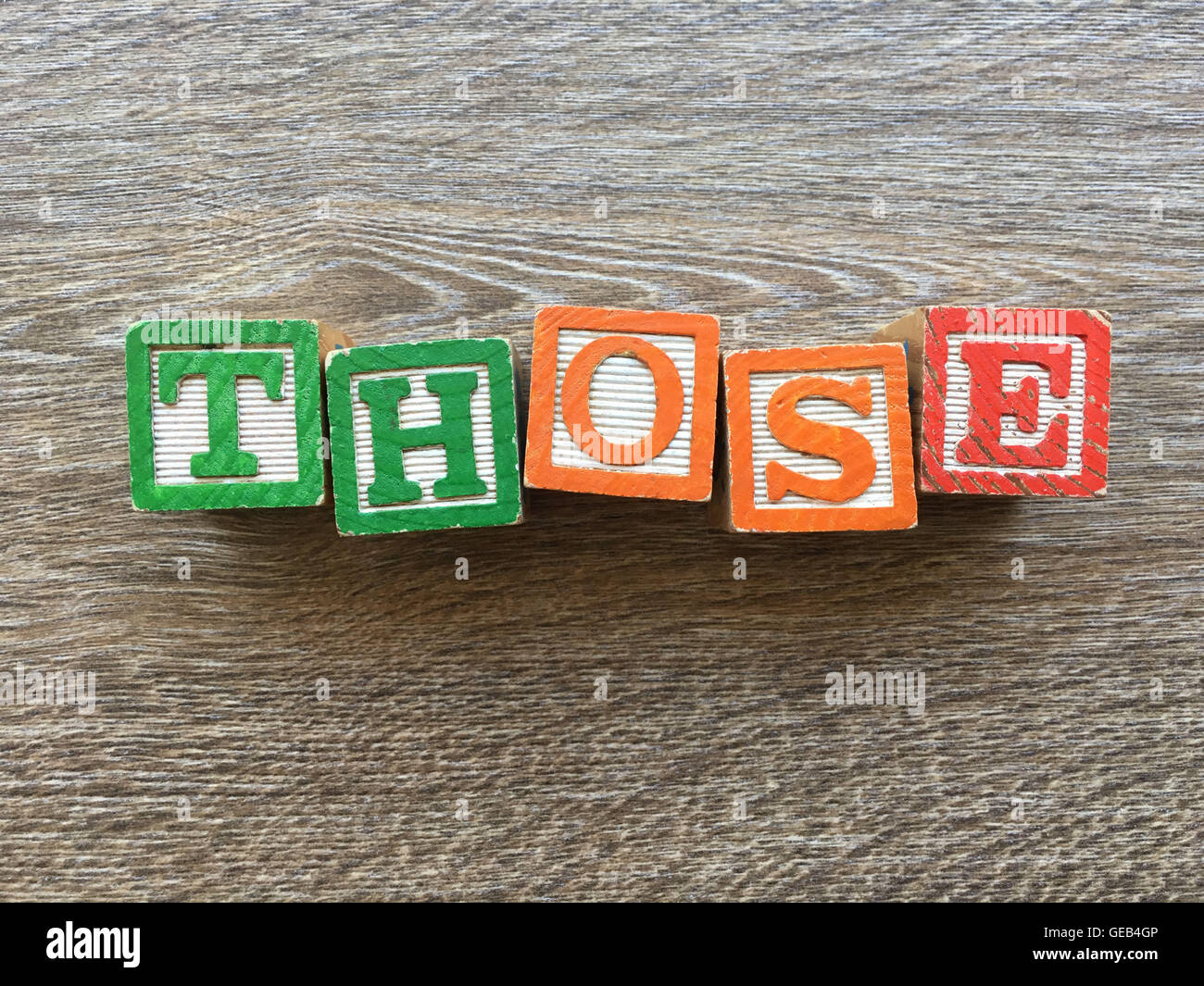 Alphabet wood block letters forming the word THOSE, combining those