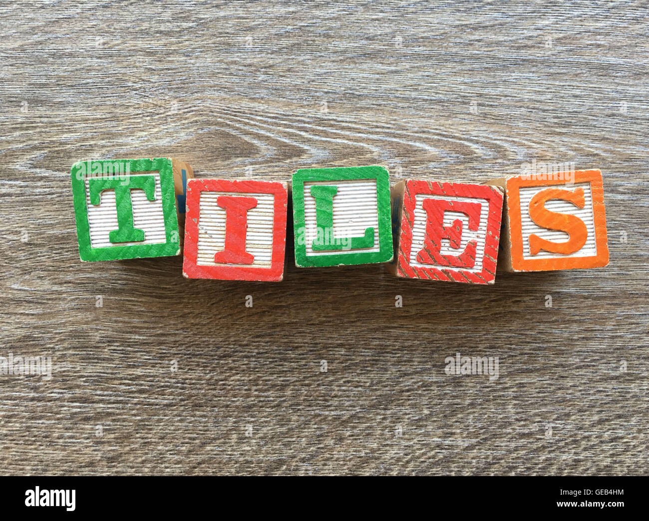 Alphabet wood block letters forming the word TILES, combining those ...
